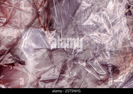 Texture of glossy polyethylene plastic sheet material crumpled and wrinkled from above Stock Photo