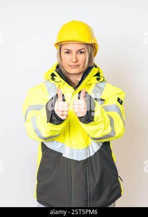 a girl in a yellow special protective jacket and a protective yellow helmet. High quality photo Stock Photo
