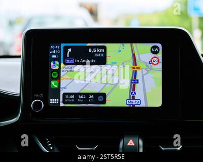 Andratx, Spain - Jun 28, 2023: A car infotainment screen displaying Apple CarPlay navigation with directions to Andratx, Mallorca, Spain, using a maps Stock Photo