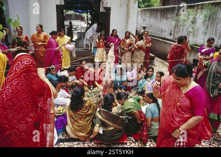 Women Worshiping holding thread, Vat Savitri Festival or Vat Purnima Festival, bombay mumbai, maharashtra, india Stock Photo