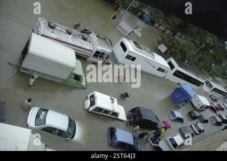 Floods due to monsoon rain showing submerged cars in flooded street ...