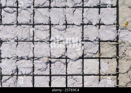Texture of Handmade Paper on a black metal grid. Stock Photo