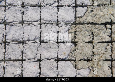 Texture of Handmade Paper on a black metal grid. Stock Photo