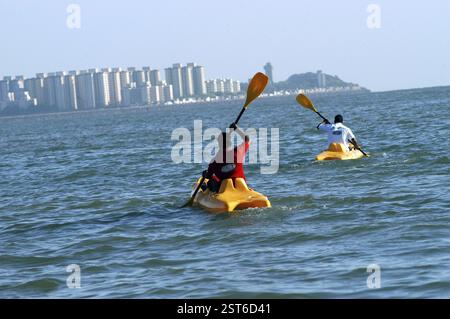 Two men canoeing in Arabian sea off Marine Drive in, now Mumbai Bombay, Maharashtra, India, Asia Stock Photo