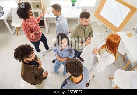 Group of multiracial people colleagues or groupmates having discussion, chatting during break. Stock Photo