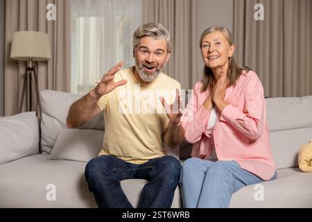 A couple watching a movie together and looking interested Stock Photo