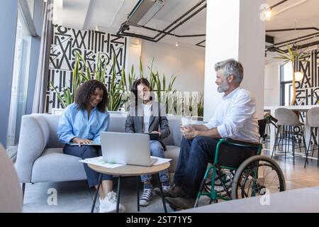 Businessman and managers working together on laptop integrating technology Stock Photo