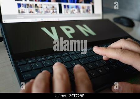 man uses app vpn creation Internet protocols for protection private network on screen computer laptop Stock Photo