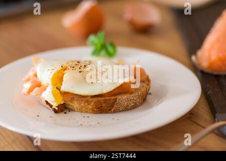 Diet breakfast with cooked egg and lightly salted red fish. Stock Photo