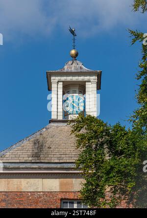 Clock on the East pavilion clock of Beningbrough Hall, seen against a blue sky on a sunny day. York, North Yorkshire, UK Stock Photo