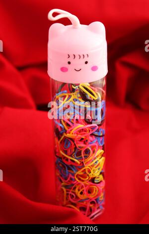Tubular container with many elastic bands Stock Photo