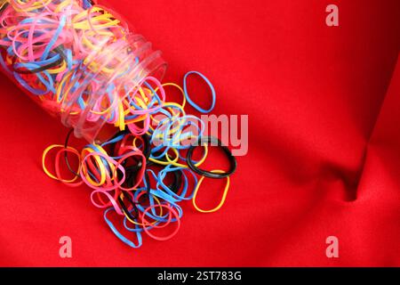 Many elastic bands coming out of container Stock Photo