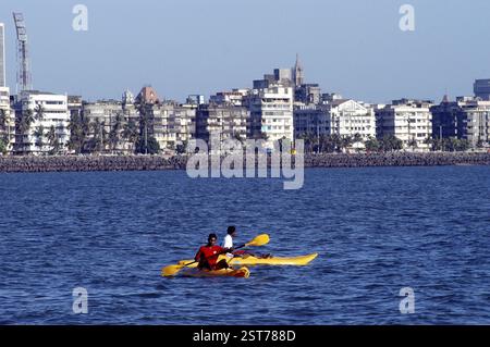 Two men canoeing in Arabian sea off Marine Drive in, Mumbai Bombay, Maharashtra, India, Asia Stock Photo
