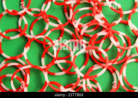 Elastic bands with red and white combination on green background Stock Photo