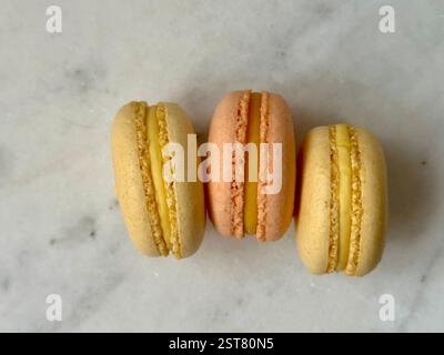 Orange and yellow macarons on the marble background Stock Photo
