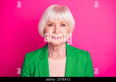 Close-up portrait of her she nice-looking attractive lovely winsome gorgeous peaceful calm gray-haired woman wearing green jacket isolated over bright Stock Photo