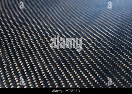 Close up pattern on a sheet of very strong carbon fiber material used in the automotive and racing industry. Stock Photo