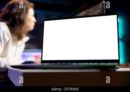 Focus on programmer using isolated screen laptop to secure company servers from virus attacks. Close up of IT remote employee writing code, building firewalls using mockup notebook Stock Photo