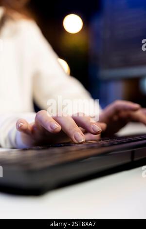 Freelancing computer scientist typing on keyboard, implementing security measures to protect company data. Close up shot of remote IT worker testing and debugging code for software applications Stock Photo