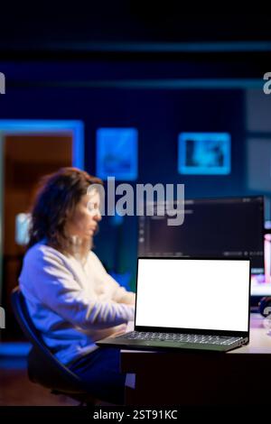 Technician using isolated screen laptop to secure company servers from virus attacks. IT remote employee writing code, building firewalls protecting data using chroma key notebook, solving tasks Stock Photo