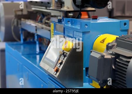 Close up of automated plastic extruder machine. Selective focus. Stock Photo
