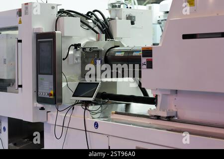 Electric plastic injection molding machine. Selective focus. Stock Photo