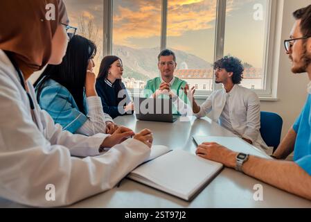 A medical team of doctors discussing at a meeting in the conference room. Stock Photo