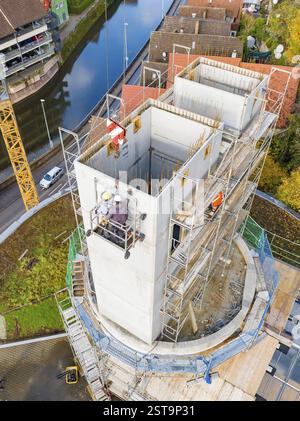 Building construction project near a river, construction workers and crane visible, extension of the Calw railway station for the new track of the Her Stock Photo