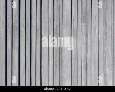 grey ribbed concrete wall with vertical stripes. rough cement plaster wall background. Stock Photo