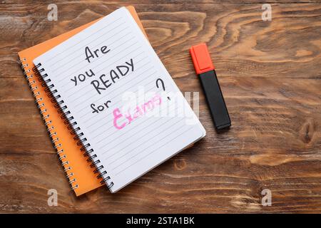 Notebooks with question ARE YOU READY FOR EXAM? and marker on brown wooden background Stock Photo