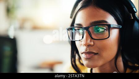 Coding, developer or woman in headphones for remote work server or processing solution. Glasses, information technology or Indian programmer on Stock Photo
