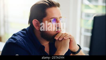 Thinking, computer and business man problem solving, brainstorming or planning in startup. Creative, serious or reflection of idea, vision or insight Stock Photo