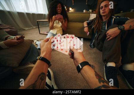 Group Playing Cards in Modern Apartment Living Room Stock Photo