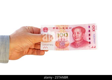 Businessman's hand wearing suit holding Renminbi money fan isolated on white background. Stock Photo