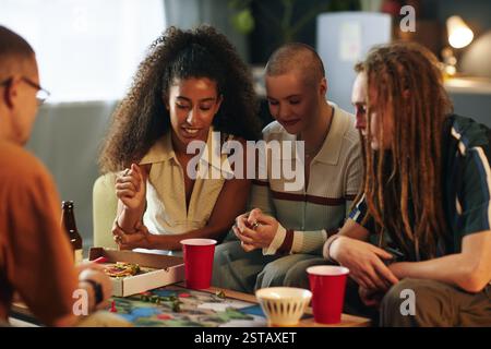 Enjoying Board Game and Pizza Night with Friends Stock Photo