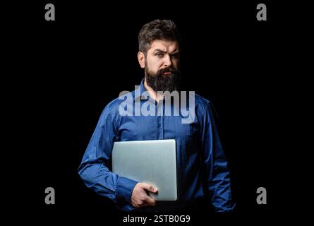 Bearded hipster with computer. Young man with beard, wearing casual shirt, standing over isolated white background, holding laptop. Handsome man hold Stock Photo