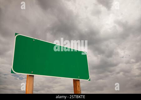 Blank Green Road Sign Over Storm Clouds Stock Photo