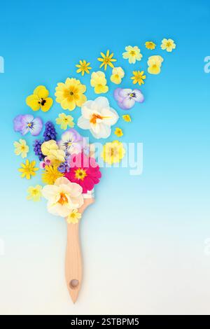 Artistic paintbrush yellow spring flower painting design on gradient blue backgtound. Floral creative seasonal nature abstract for fun greeting card. Stock Photo