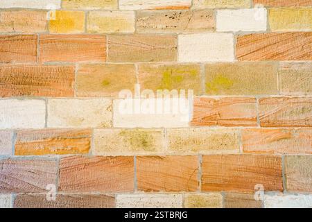 Natural stone wall in orange and beige. Background from natural materials. Stock Photo
