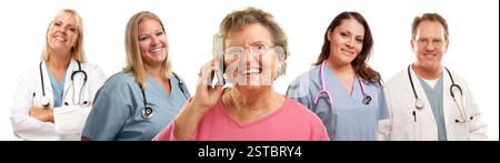 Happy Senior Woman Using Cell Phone and Doctors Behind Stock Photo