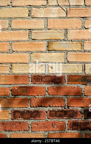 Weathered orange color brick wall for brickwork background design Stock Photo