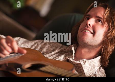 Young Musician Plays His Acoustic Guitar Stock Photo