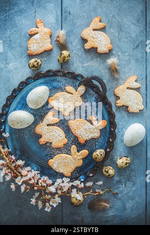 Homemade almond bunny cookies for Easter with Easter eggs in blue tone Stock Photo
