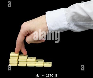 Ascension on a pedestal from dominoes Stock Photo