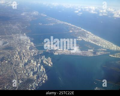 Aerial view Miami cityscape turquoise water, cruise ships, Miami Beach distance. Bustling metropolis sea. Beach vacation destination. Stock Photo