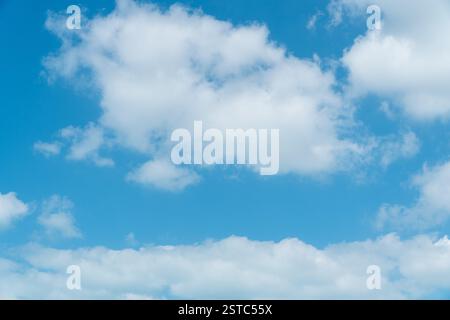 Beautiful large white scattered clouds on a blue sky above during the day. Stock Photo