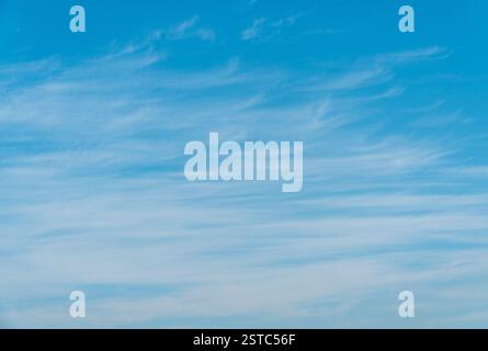 beautiful blue sky with some floating whispy clouds. Stock Photo