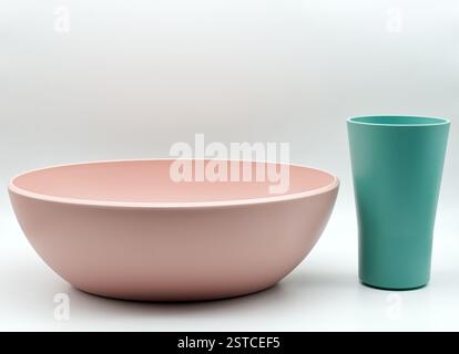 Modern pink bowl and teal cup set isolated on white background Stock Photo