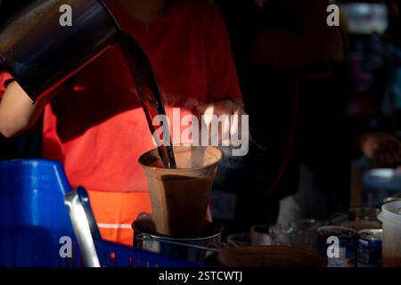 Making Traditional Thai Street Coffee (Oliang) by Pouring Hot Water Through a Cloth Filter Stock Photo