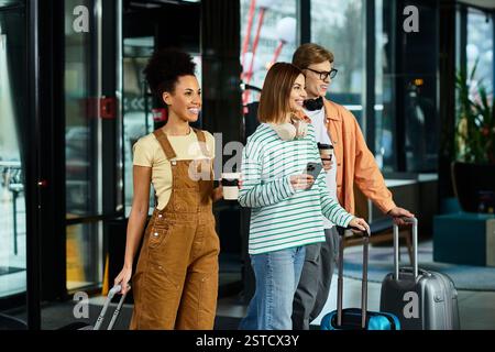 Three colleagues arrive at a hotel, each carrying luggage and holding drinks while chatting. Stock Photo